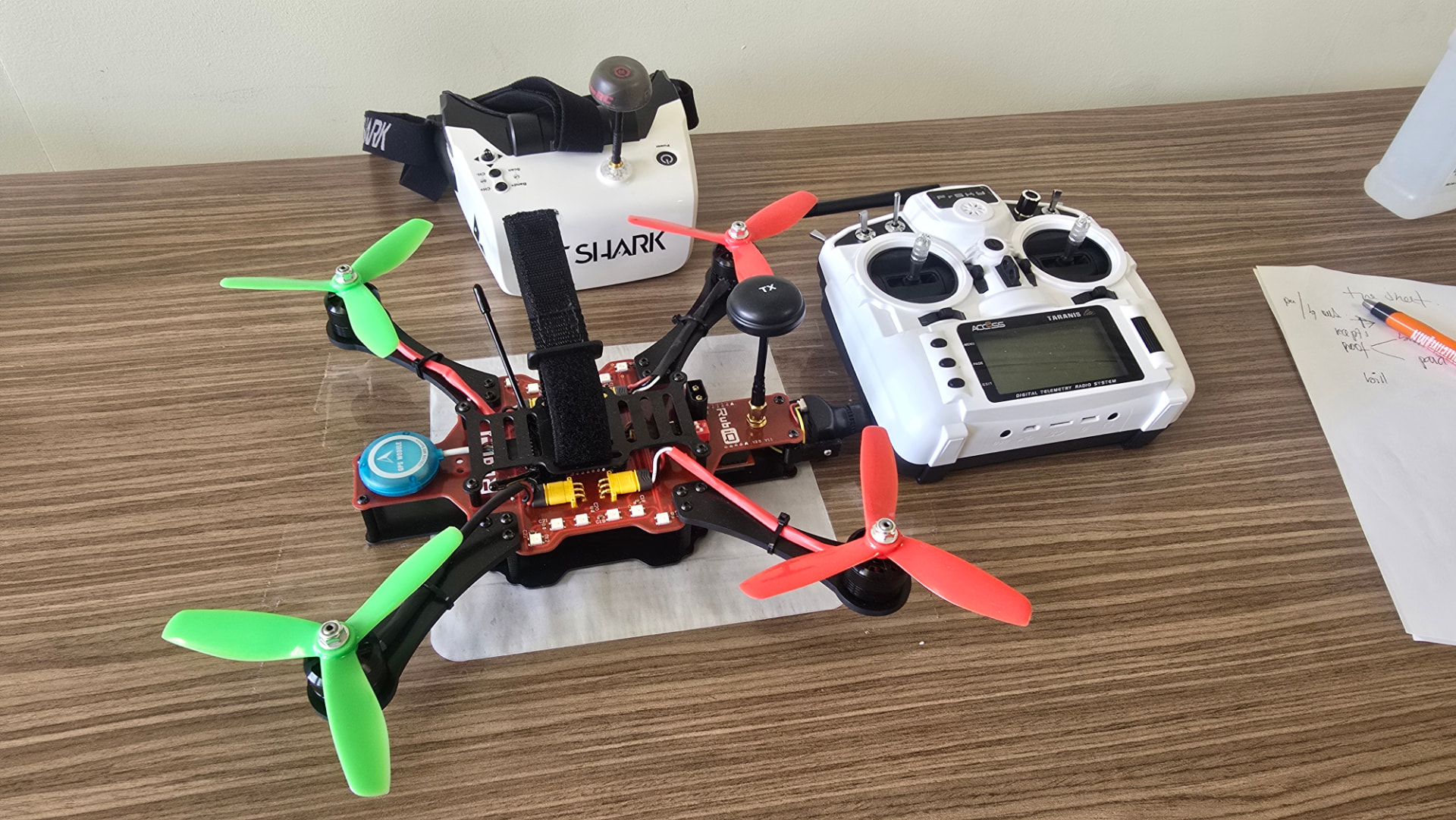 A completed drone displayed with its radio controller and flight goggles following a drone building workshop.